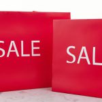 close-up-shot-of-red-shopping-bags-on-a-marble-surface-940x510