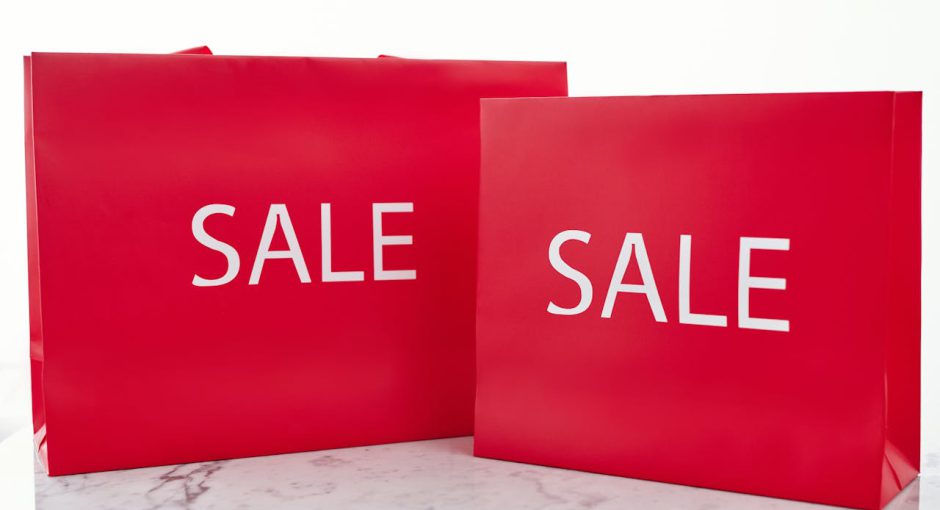 close-up-shot-of-red-shopping-bags-on-a-marble-surface-940x510